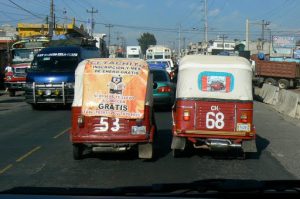 Local taxis on the busy road to Lake Atitlan