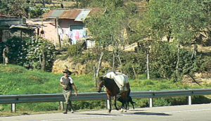 On the busy road to Lake Atitlan: many local peasant