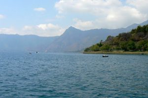 Along the shoreline of Lake Atitlan are high hills and