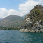 Along the shoreline of Lake Atitlan are high hills and