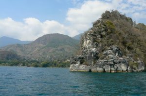 Along the shoreline of Lake Atitlan are high hills and