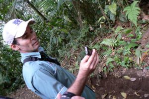 Guide imitating a bird call with his phone