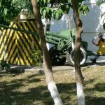 A woman sitting on a cannon (left over from the