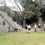 Typical tourist group getting an explanation of a stela