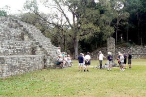 Typical tourist group getting an explanation of a stela