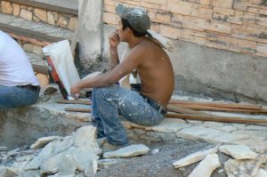 Local worker making sidewalk repairs