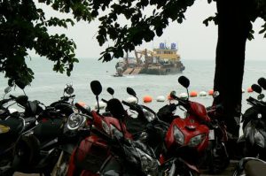Motorbikes everywhere with dredge offshore