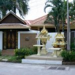 Private home with fancy spirit house in front