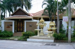 Private home with fancy spirit house in front