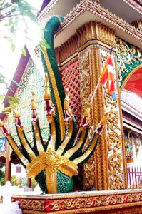 Multi-headed naga serpent guarding a temple entry against evil spirits