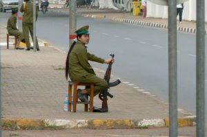 Female soldier on duty with shoes off