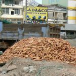 Bricks being unloaded by hand at a construction site