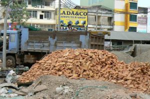 Bricks being unloaded by hand at a construction site