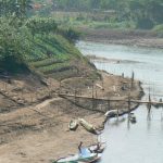 Boys playing along the Nam Khan River. The Nam Khan River