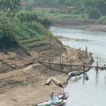 Boys playing along the Nam Khan River. The Nam Khan River