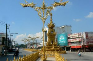 Golden clock tower and decorative standards in central city; built by