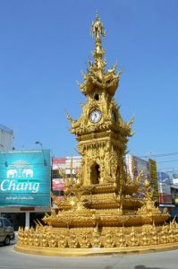 Golden clock tower and decorative standards in central city;  built