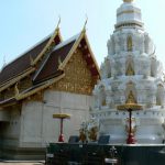 A rather elaborate chedi with niches around its three-tiered base.