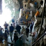 Tourists looking at the lower cave and sculptures