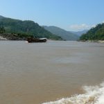 Looking north at the forested hills; tourist boat in the