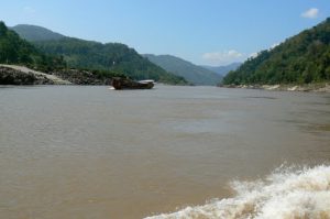 Looking north at the forested hills; tourist boat in the