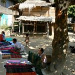 Hmong villagers selling colorful weavings