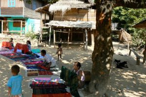 Hmong villagers selling colorful weavings