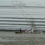 Family canoe passing sand patterns along the banks of the