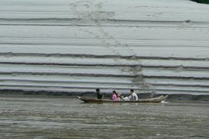 Family canoe passing sand patterns along the banks of the