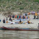 An informal clothing market along the river