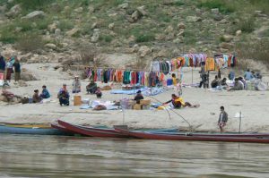 An informal clothing market along the river