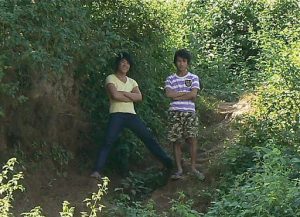 Teens watching tourists from a distance; what are they thinking?