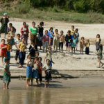 Local kids bidding farewell to the day's load of tourists