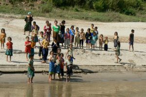 Local kids bidding farewell to the day's load of tourists