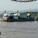 Trucks cross between Thailand and Laos by small ferry