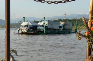 Trucks cross between Thailand and Laos by small ferry