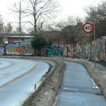 Along the periphery of Christiania is a long fence decorated