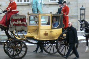 The queen and her husband pass by