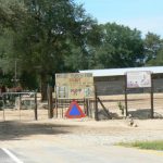 Schoolyard north of Okavango Delta with AIDS prevention poster