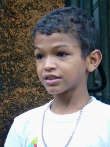 Boy dancer with the can band;  he stopped to dance