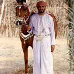 Oman - man in dishdasha gown, muzzar turban and khanjar