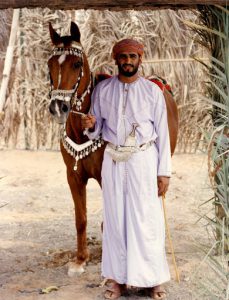 Oman - man in dishdasha gown, muzzar turban and khanjar