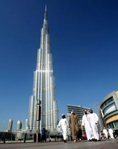 Emirati men walk past Burj Dubai, the world's tallest tower,