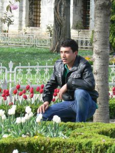 Turkey, Istanbul - visitor posing in Sultan's Garden at Blue