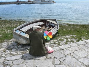 Macedonia, Ohrid City - old man with his rainbow pinwheel