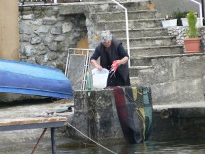 Macedonia, Ohrid City - local woman washing a carpet