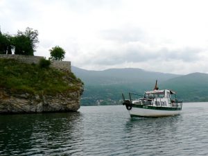 Macedonia, Ohrid Lake - small tour boats cruise the coastline