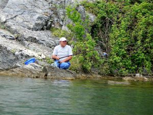 Macedonia, Ohrid Lake - peaceful fisherman among prehistoric rock