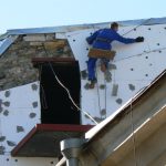 Ukraine, Odessa - applying foam insulation to an old builidng