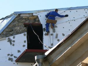 Ukraine, Odessa - applying foam insulation to an old builidng